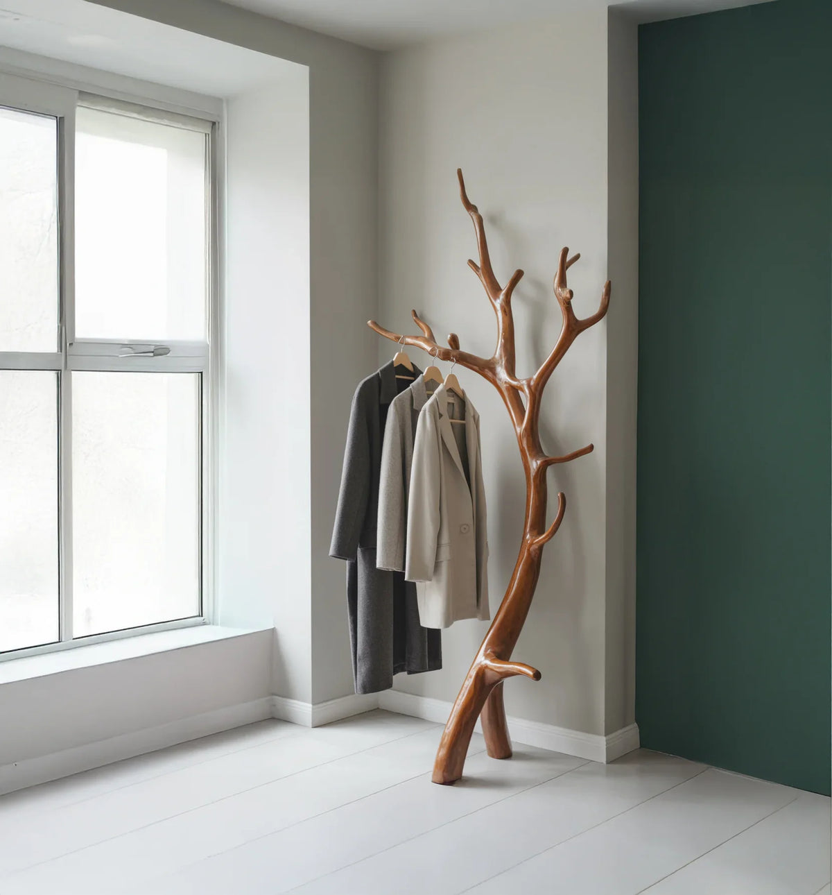 Live edge wood tree coat rack with hanging jackets in modern minimalist room