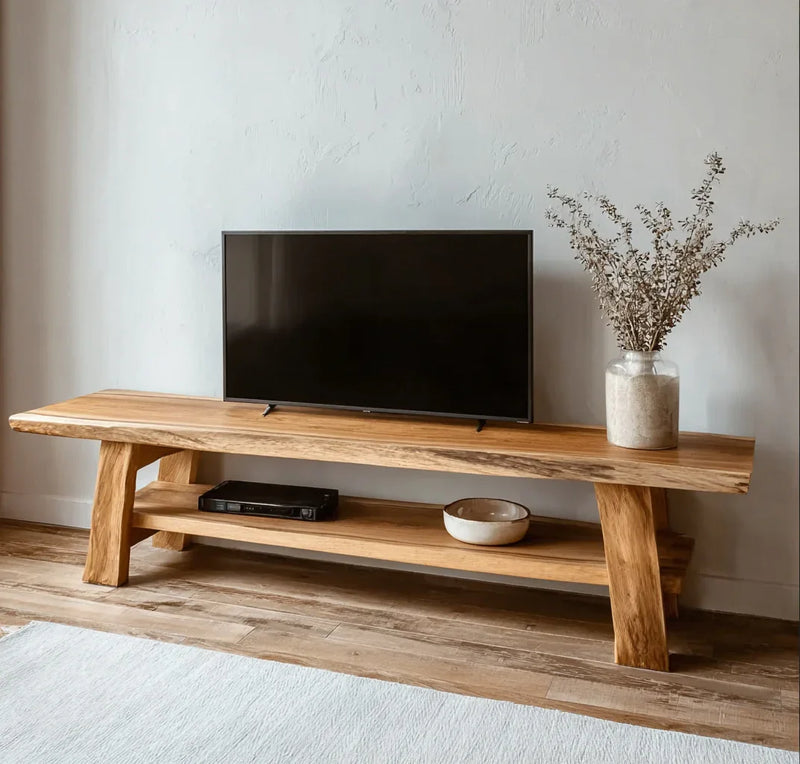 Minimalist wooden TV stand with flat-screen TV, ceramic bowl, and dried flower vase in neutral living room