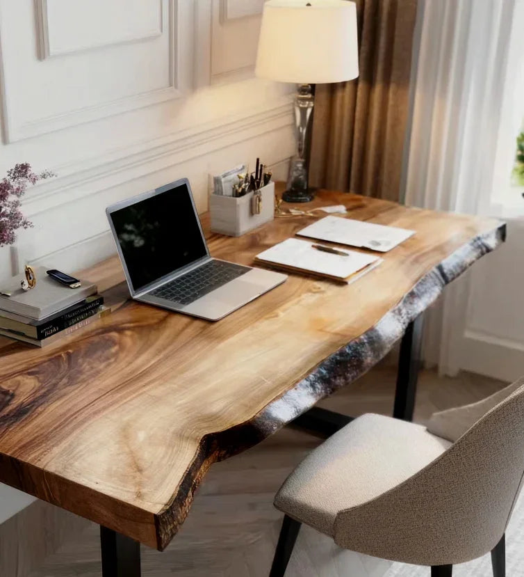 Modern home office setup with live edge wooden desk, laptop, papers, lamp, chair