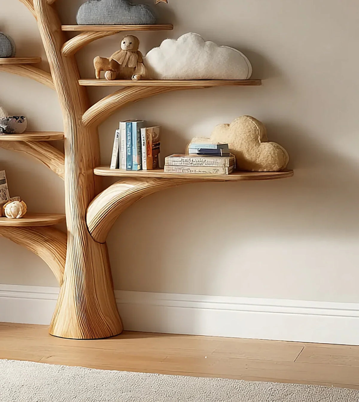 Solid wood tree bookshelf with books, plush toys, and cloud-shaped pillows on shelves.