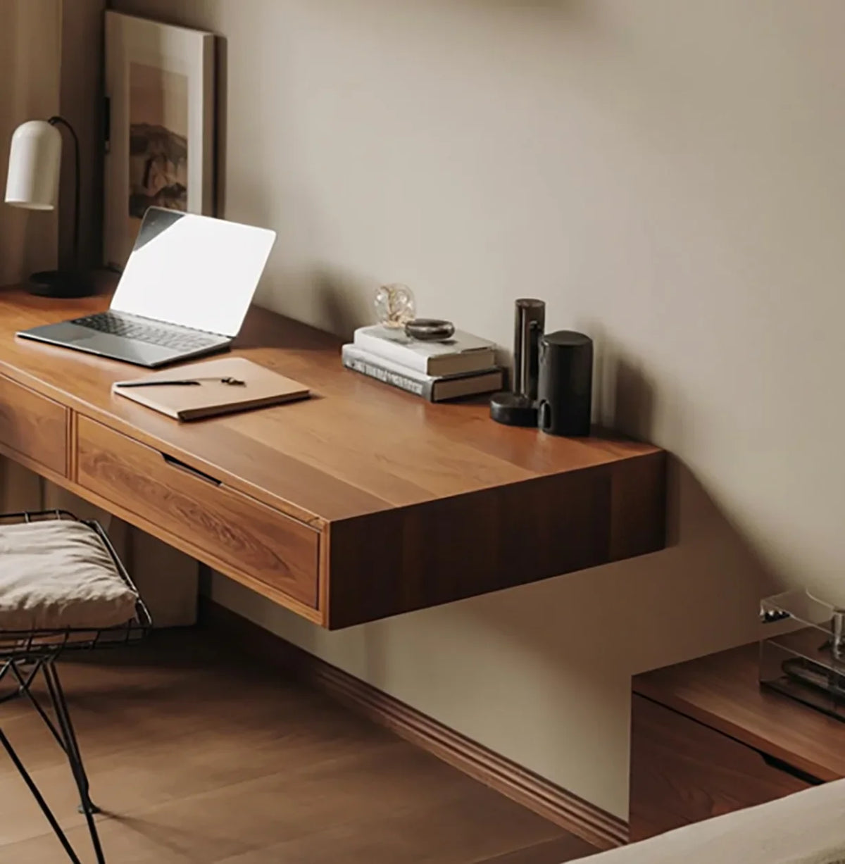 Solid wood floating desk with laptop and books in a modern home office setting