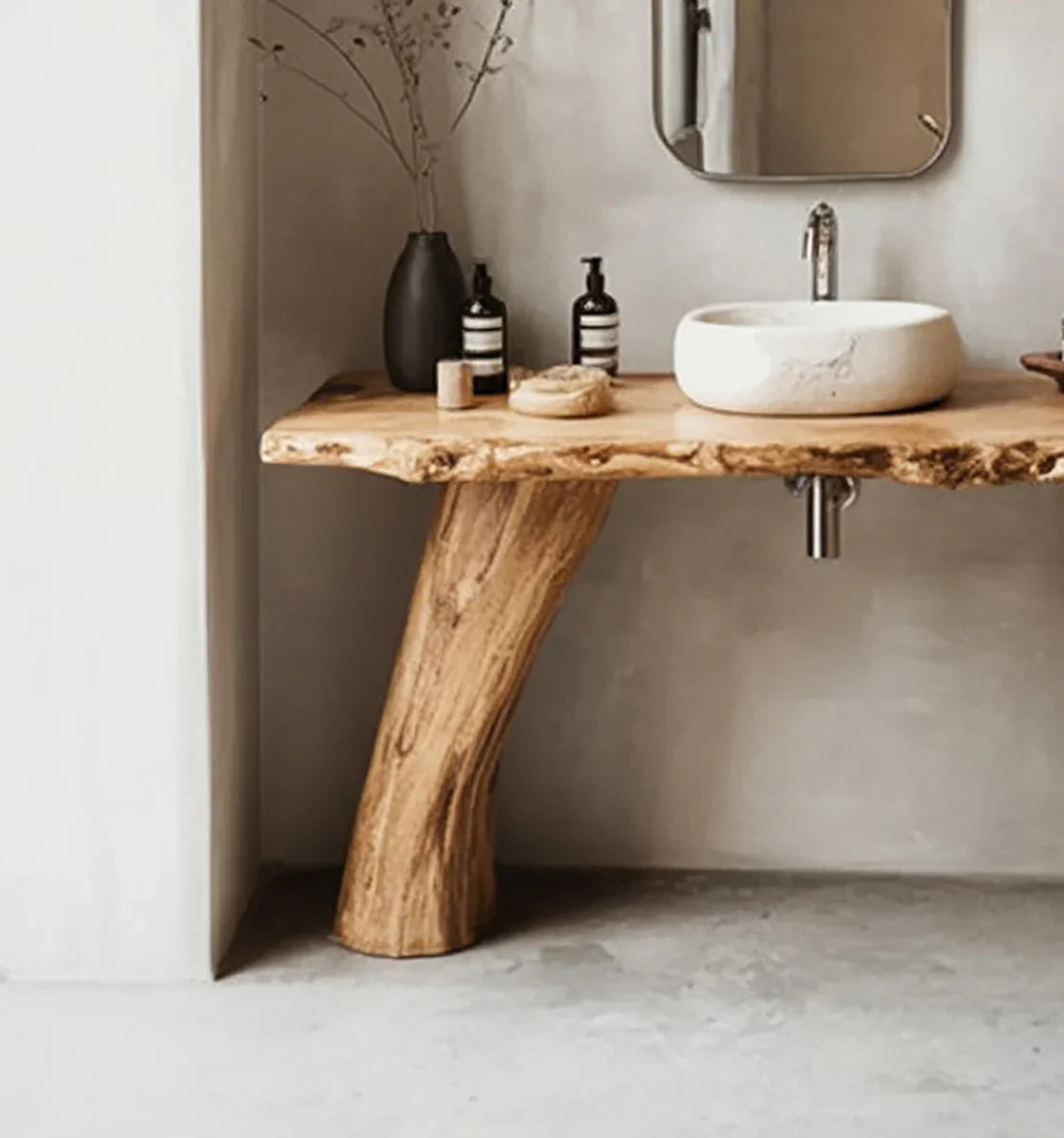 Live edge solid wood bathroom vanity with stone sink and minimalist decor.