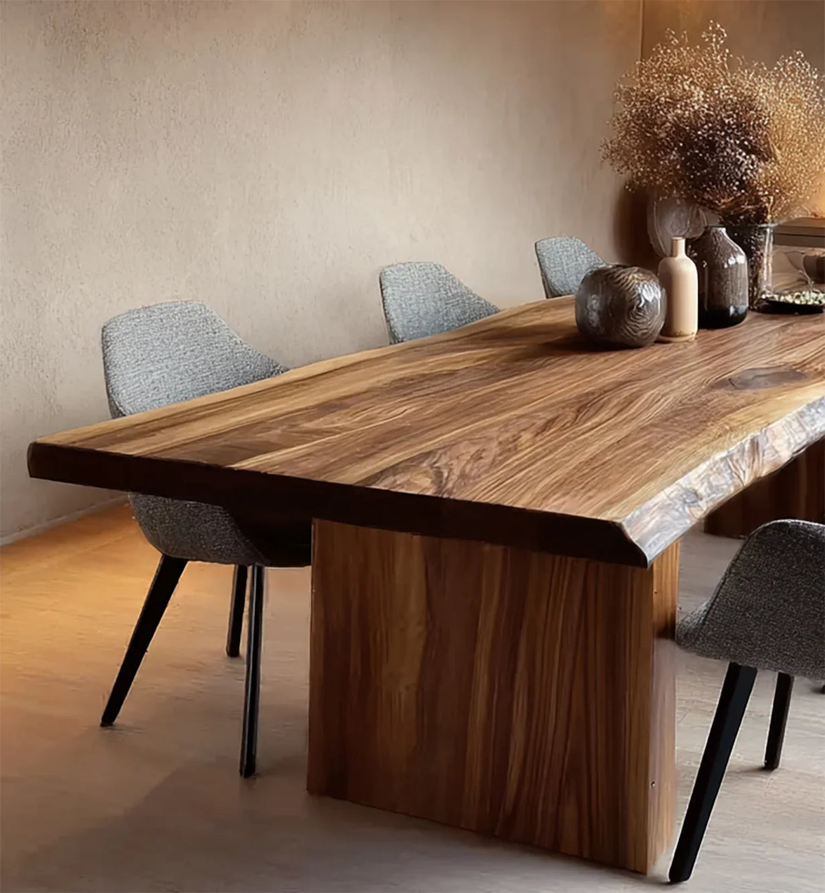 Modern dining table with live edge wood top and gray upholstered chairs in minimalist room