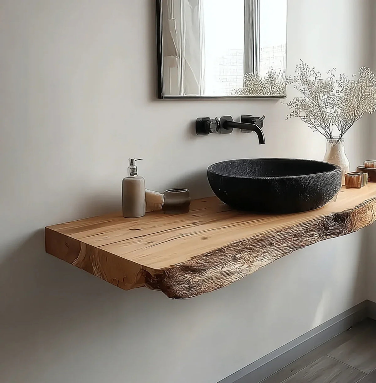 Modern bathroom with floating live edge wooden vanity, black stone sink, wall-mounted faucet, and decorative vase