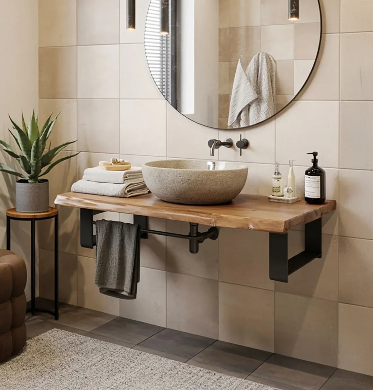 Modern bathroom with stone vessel sink on wooden countertop, round mirror, and potted plant